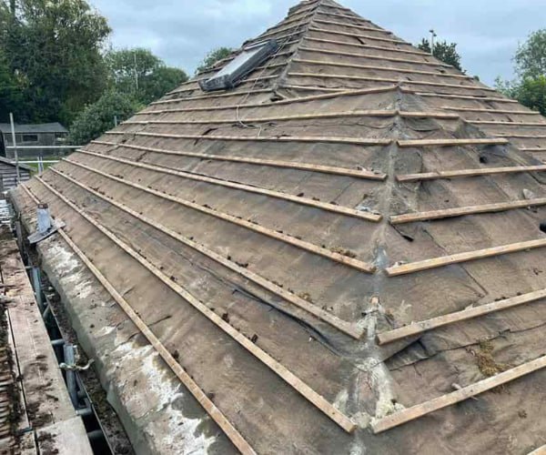 This is a photo of a hip roof that has been stripped back to the battens, and is awaiting a new roof covering to be installed. Works carried out by BMT Roofing Wollaston