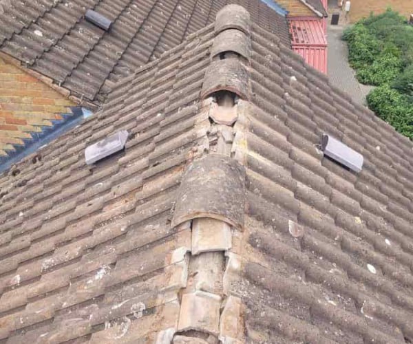 This is a photo if a roof ridge which has missing tiles. The ridge tiles are being replaced by BMT Roofing Wollaston